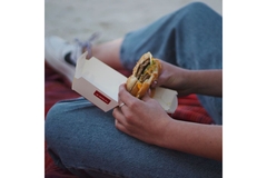 Eating fast-food burger.